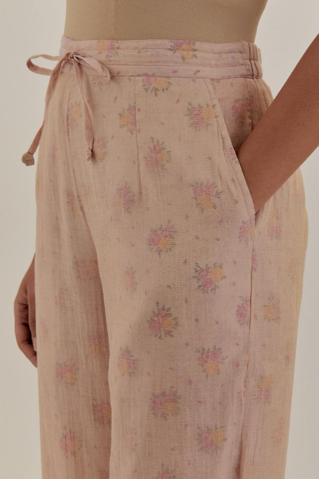 Pink tissue chanderi straight pants with light gold dori embroidery at hem.