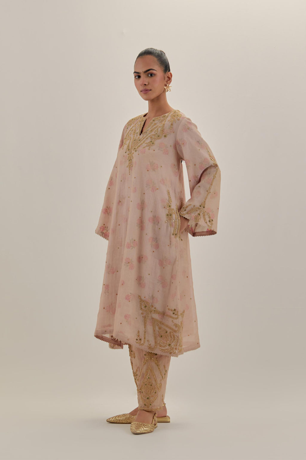 Pink tissue chanderi A-line kurta set highlighted with light gold dori embroidery and hand block printed lining inside.