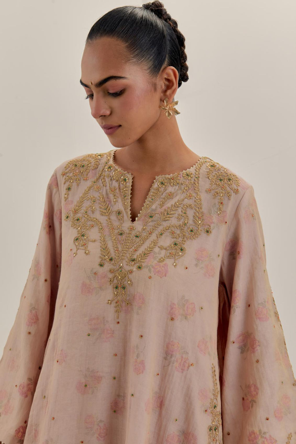 Pink tissue chanderi A-line kurta set highlighted with light gold dori embroidery and hand block printed lining inside.