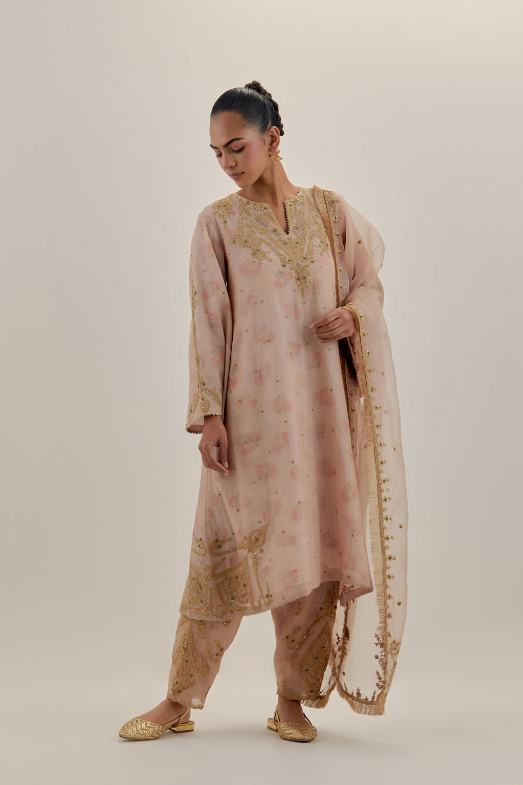 Pink tissue chanderi A-line kurta set highlighted with light gold dori embroidery and hand block printed lining inside.