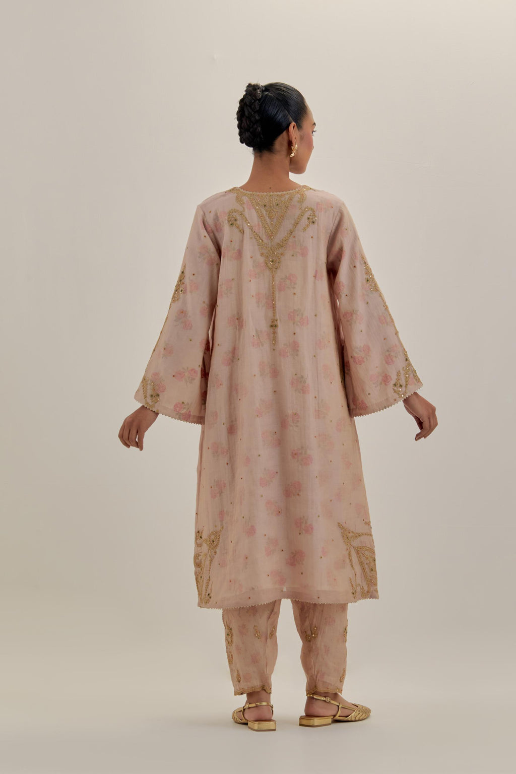 Pink tissue chanderi A-line kurta set highlighted with light gold dori embroidery and hand block printed lining inside.