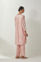 Pink silk Chandri straight short kurta with all-over off white silk thread embroidery, highlighted with beads and sequins work,  paired with Pink silk Chanderi straight pants with embroidered boota at sides, highlighted with sequins and beads.