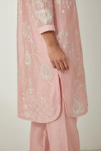 Pink silk Chandri straight short kurta with all-over off white silk thread embroidery, highlighted with beads and sequins work,  paired with Pink silk Chanderi straight pants with embroidered boota at sides, highlighted with sequins and beads.