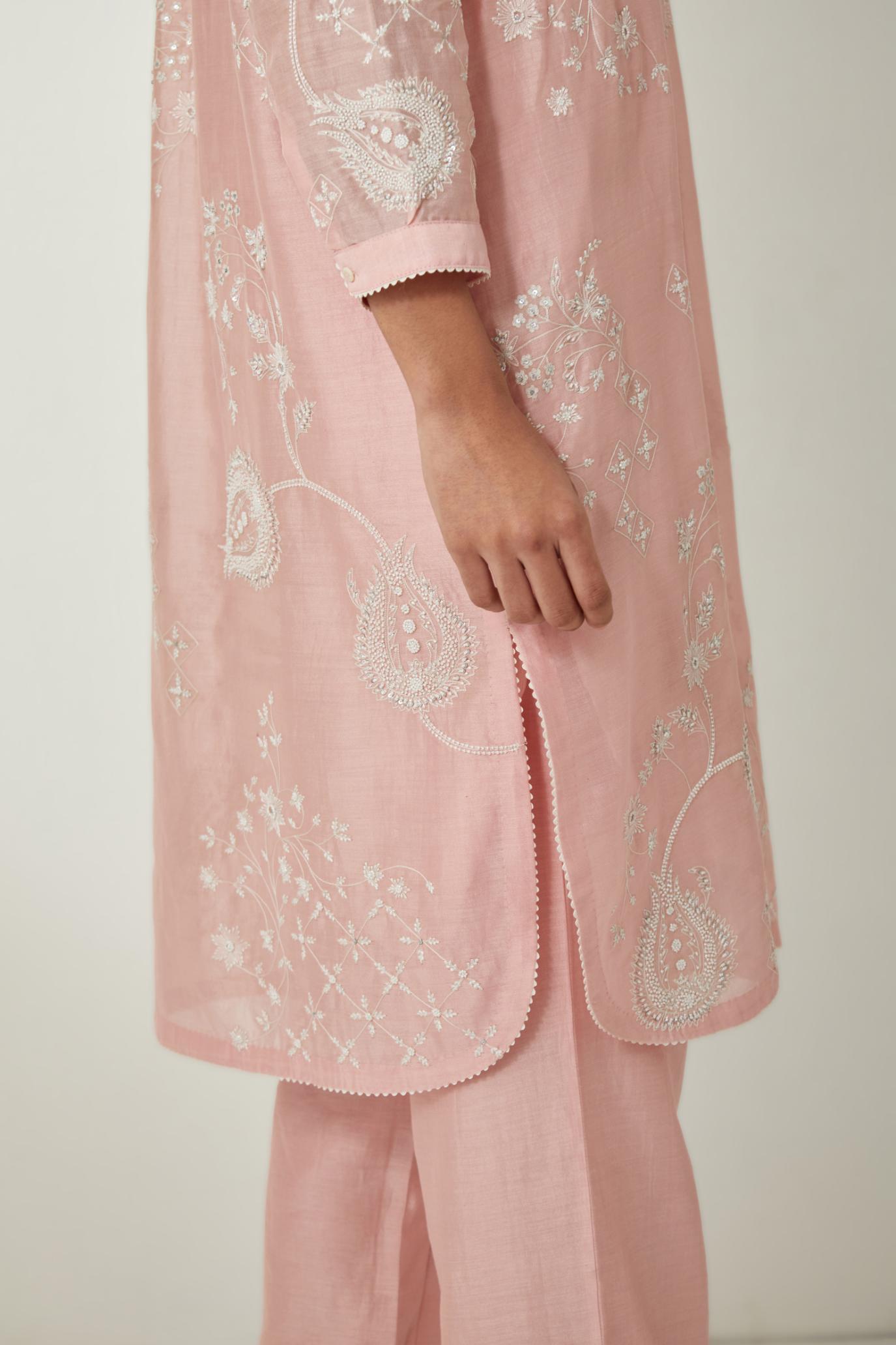 Pink silk Chandri straight short kurta with all-over off white silk thread embroidery, highlighted with beads and sequins work,  paired with Pink silk Chanderi straight pants with embroidered boota at sides, highlighted with sequins and beads.