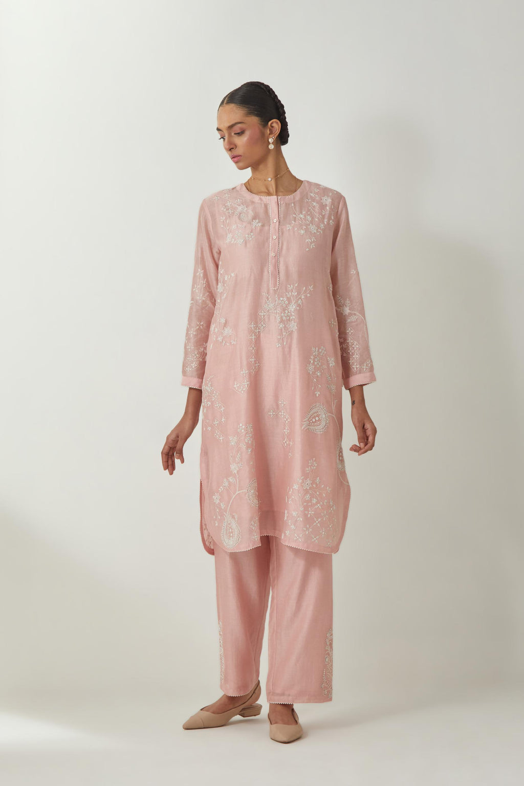 Pink silk Chandri straight short kurta with all-over off white silk thread embroidery, highlighted with beads and sequins work,  paired with Pink silk Chanderi straight pants with embroidered boota at sides, highlighted with sequins and beads.
