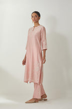 Pink silk Chanderi straight mid length kurta set with all-over off white silk thread embroidery, highlighted with beads, and sequins work at neck & hem.
