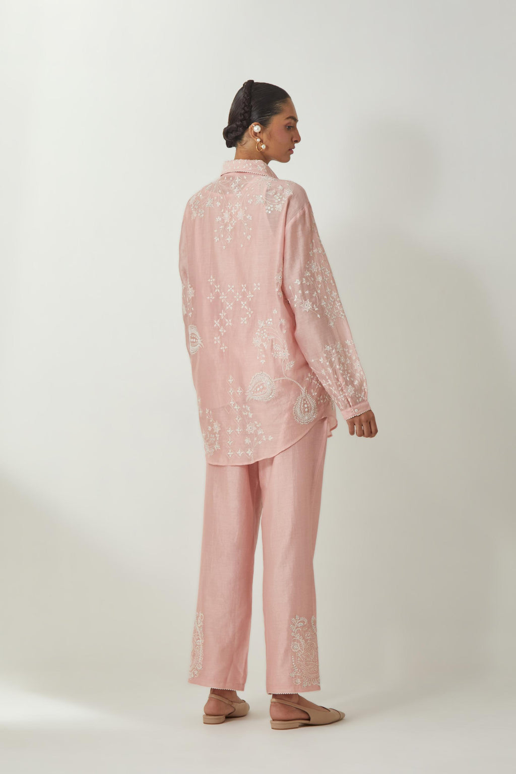 Pink silk Chanderi shirt with all-over off white silk thread embroidery, highlighted with sequins and beads work, paired with Pink silk Chanderi straight pants with embroidered boota at sides, highlighted with sequins and beads.