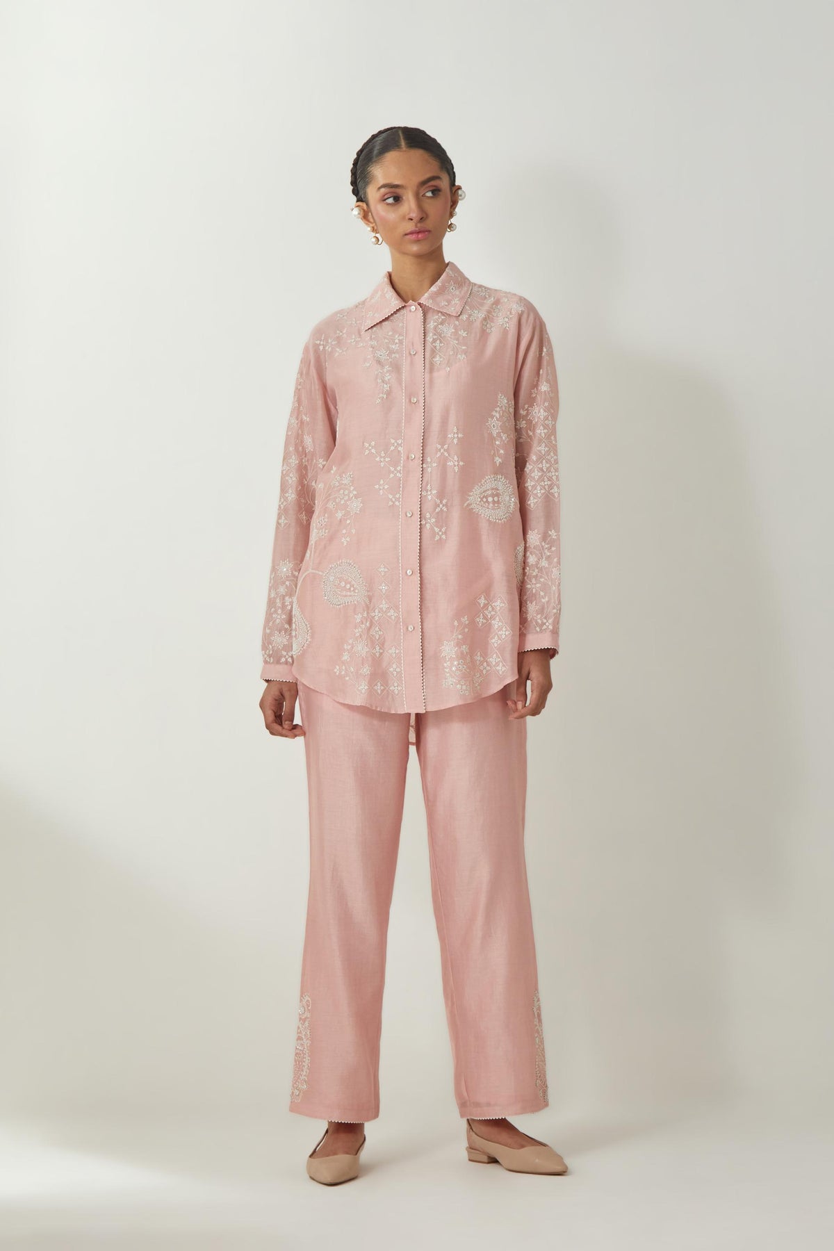 Pink silk Chanderi shirt with all-over off white silk thread embroidery, highlighted with sequins and beads work, paired with Pink silk Chanderi straight pants with embroidered boota at sides, highlighted with sequins and beads.