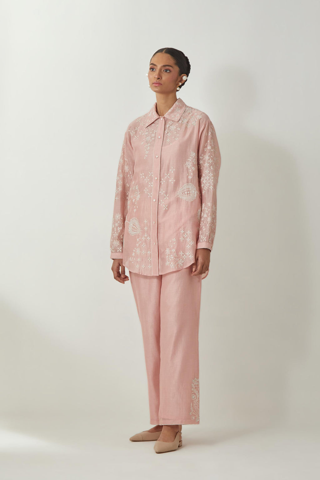Pink silk Chanderi shirt with all-over off white silk thread embroidery, highlighted with sequins and beads work, paired with Pink silk Chanderi straight pants with embroidered boota at sides, highlighted with sequins and beads.