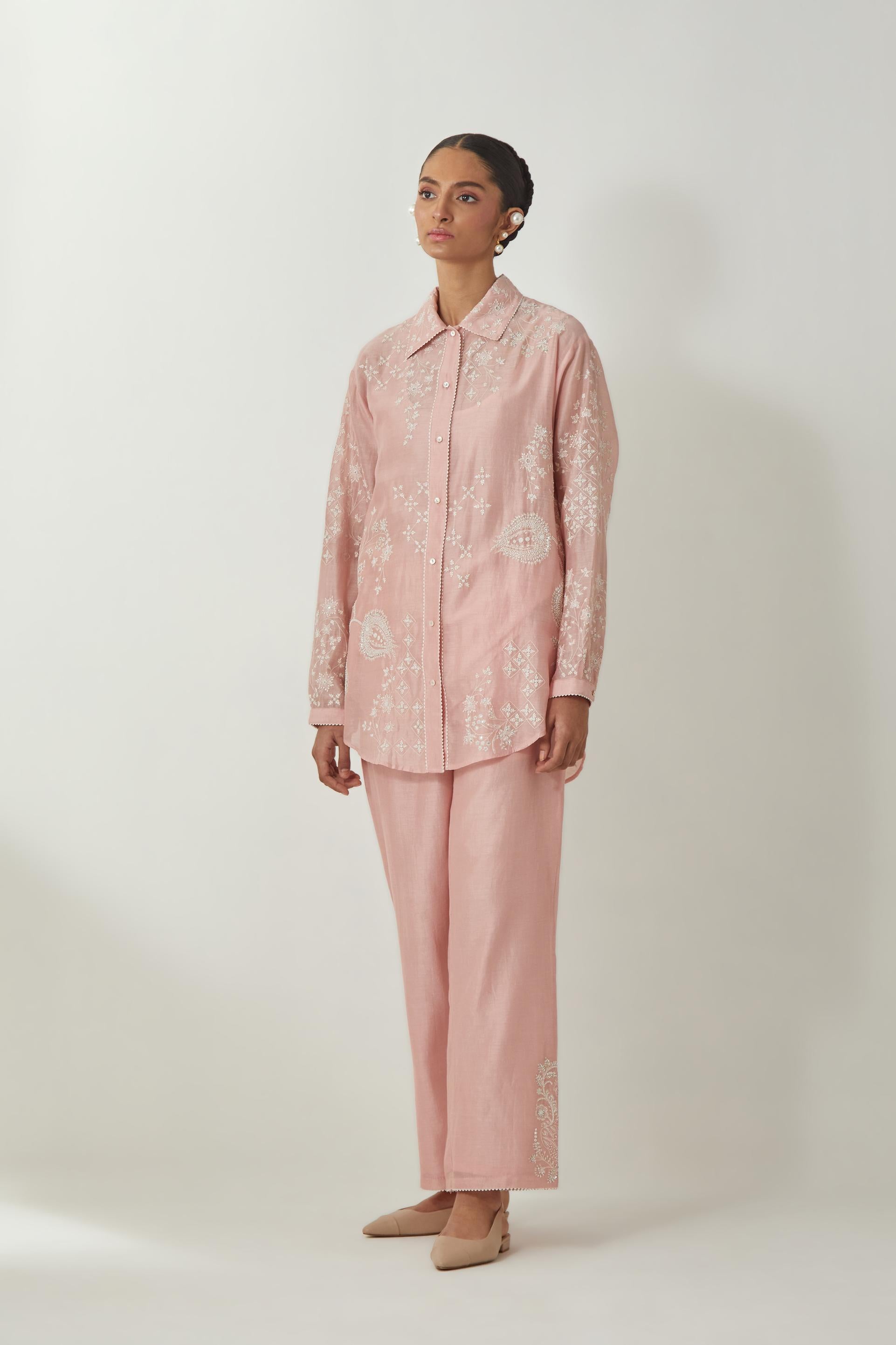 Pink silk Chanderi shirt with all-over off white silk thread embroidery, highlighted with sequins and beads work, paired with Pink silk Chanderi straight pants with embroidered boota at sides, highlighted with sequins and beads.