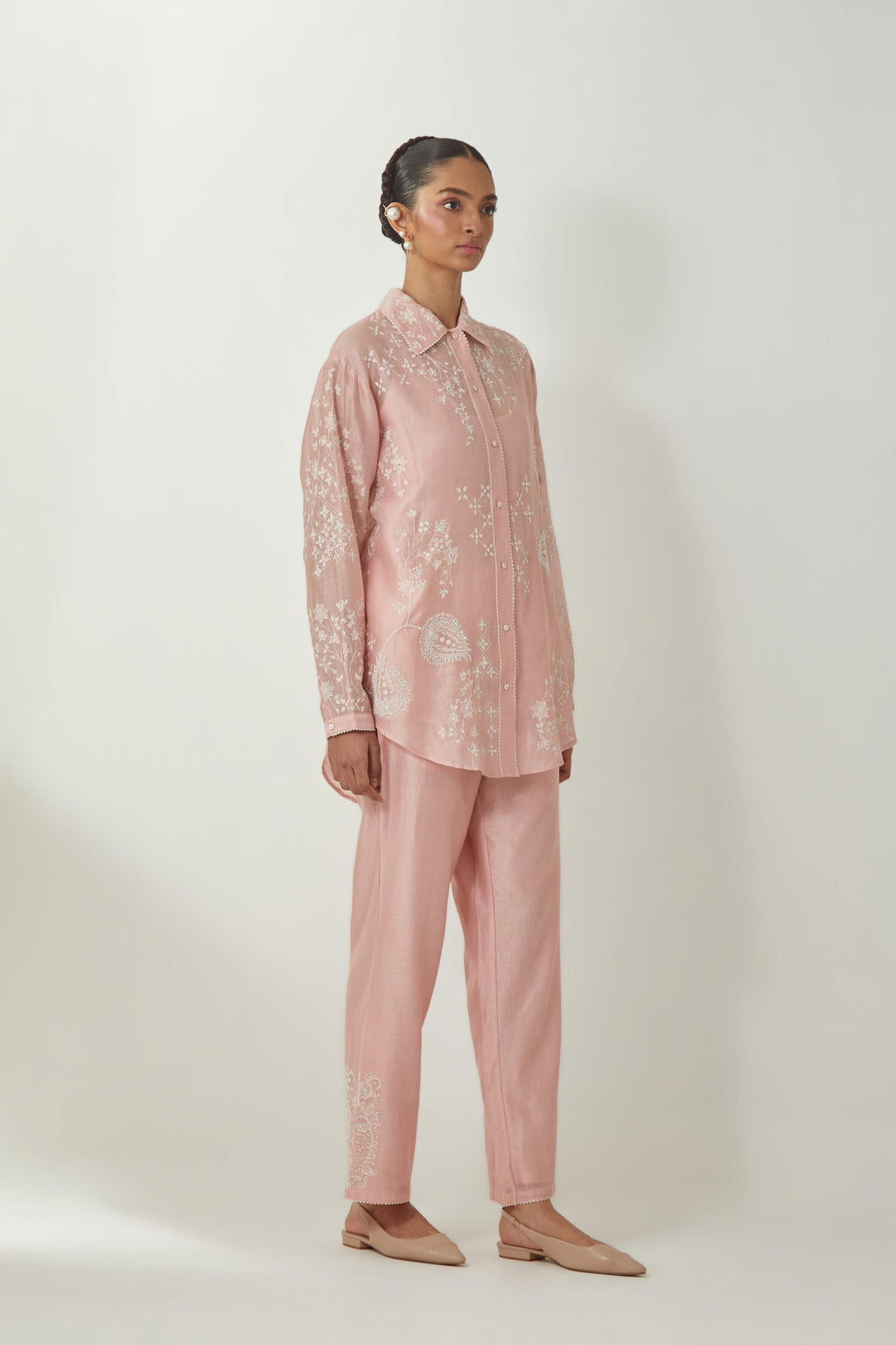 Pink silk Chanderi shirt with all-over off white silk thread embroidery, highlighted with sequins and beads work, paired with Pink silk Chanderi straight pants with embroidered boota at sides, highlighted with sequins and beads.