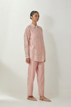 Pink silk Chanderi shirt with all-over off white silk thread embroidery, highlighted with sequins and beads work, paired with Pink silk Chanderi straight pants with embroidered boota at sides, highlighted with sequins and beads.