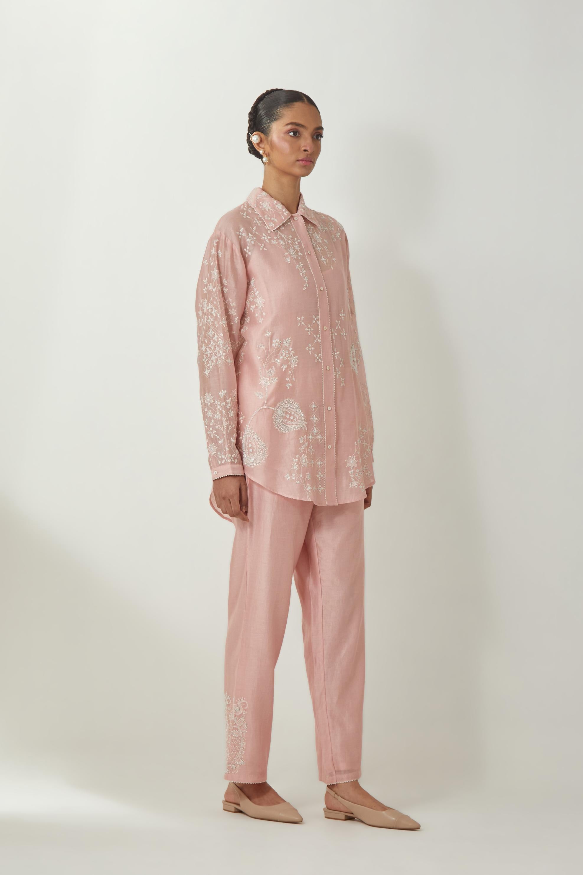 Pink silk Chanderi shirt with all-over off white silk thread embroidery, highlighted with sequins and beads work, paired with Pink silk Chanderi straight pants with embroidered boota at sides, highlighted with sequins and beads.