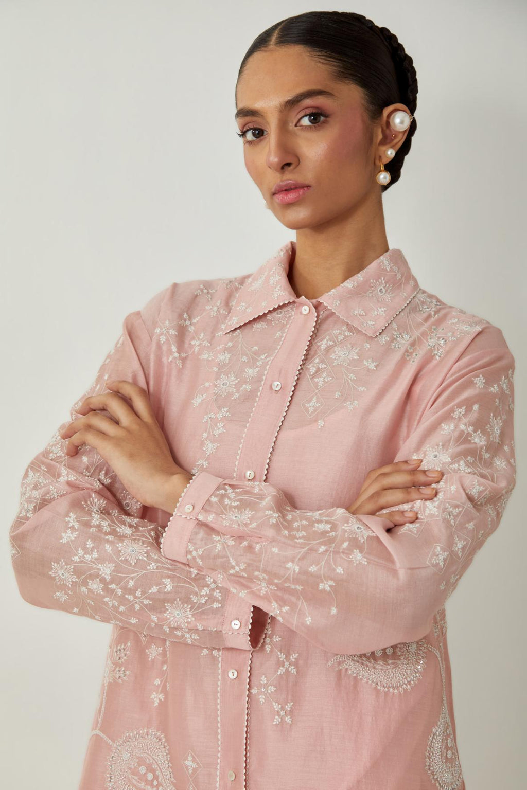 Pink silk Chanderi shirt with all-over off white silk thread embroidery, highlighted with sequins and beads work, paired with Pink silk Chanderi straight pants with embroidered boota at sides, highlighted with sequins and beads.