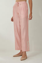 Pink silk Chanderi straight pants with embroidered boota at sides, highlighted with sequins and beads.