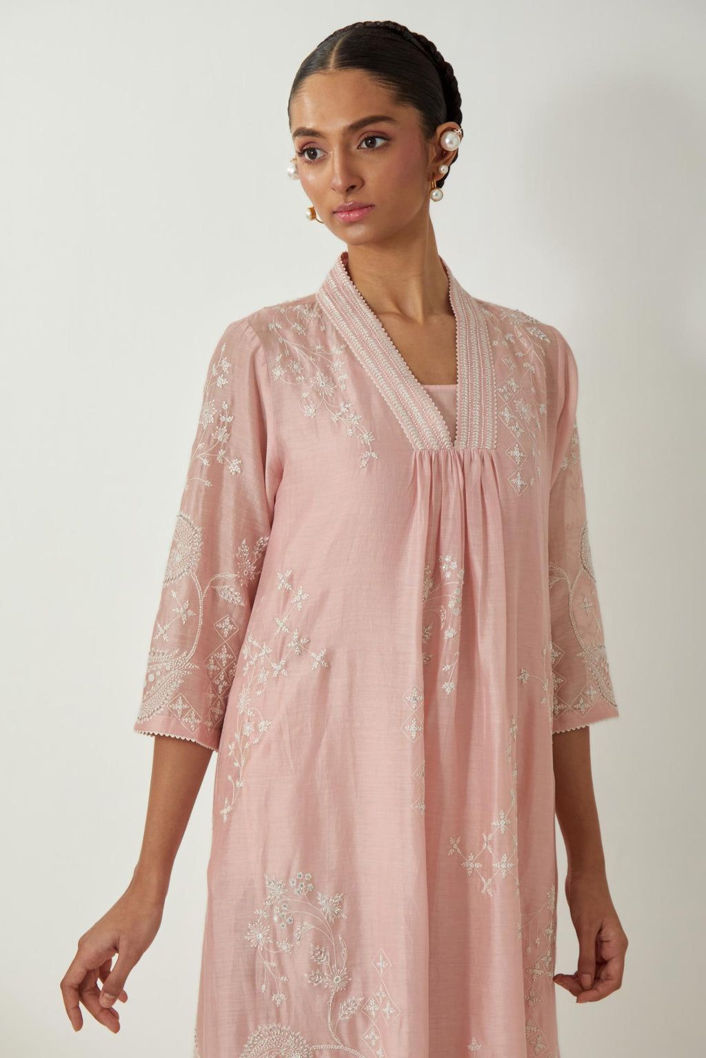 Pink silk Chanderi easy fit dress with all-over off white silk thread embroidery, highlighted with beads and sequins work.