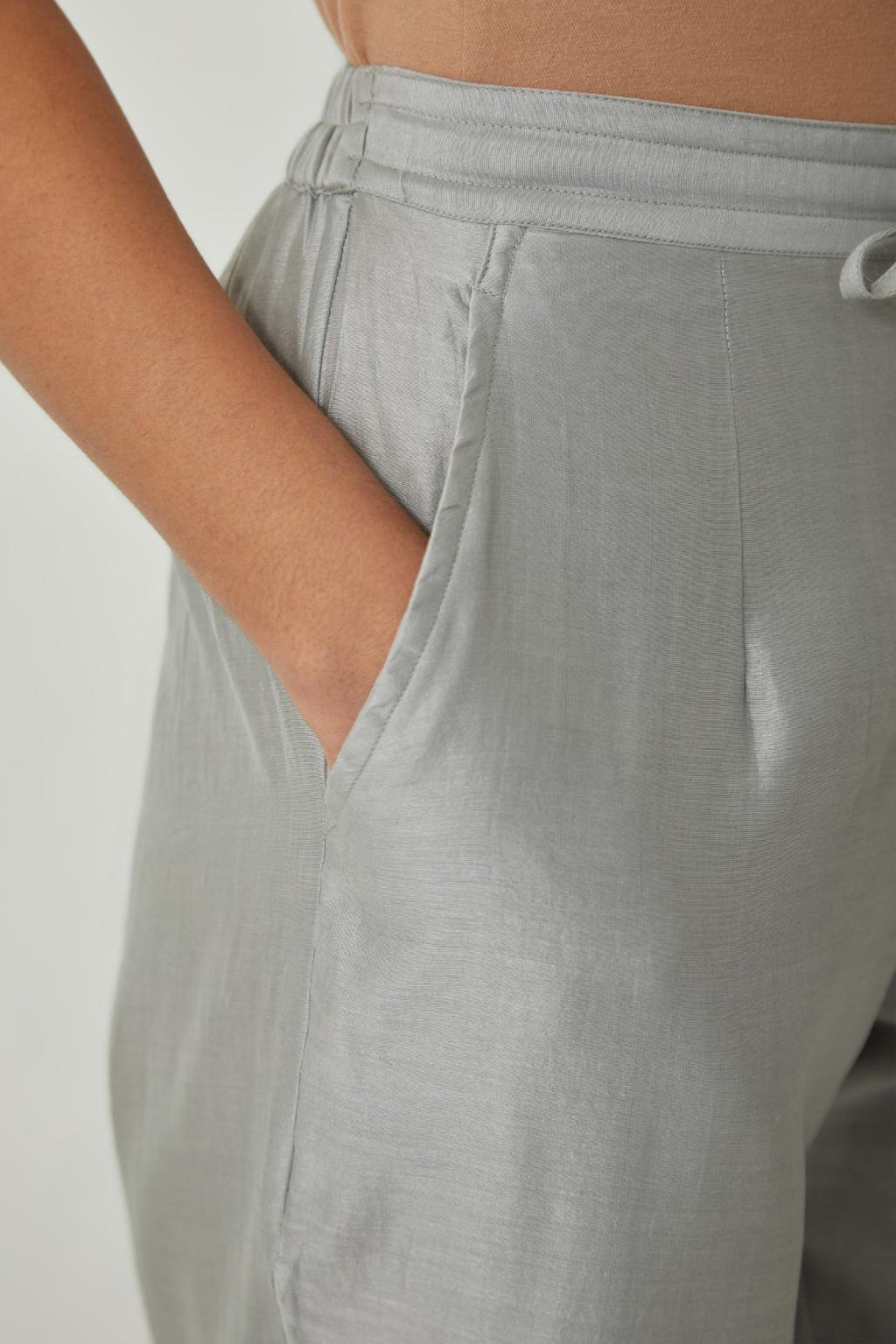 Bluish Grey silk Chanderi straight pants with embroidered boota at sides, highlighted with sequins and beads.