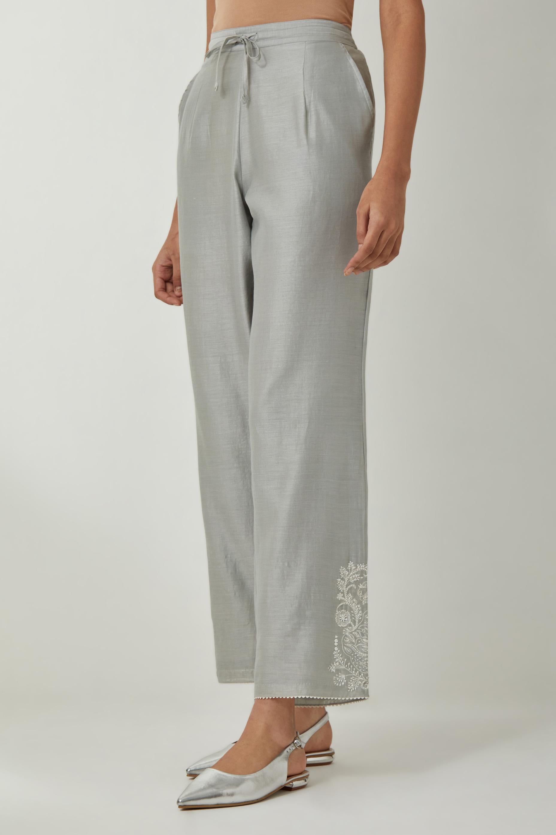 Bluish Grey silk Chanderi straight pants with embroidered boota at sides, highlighted with sequins and beads.