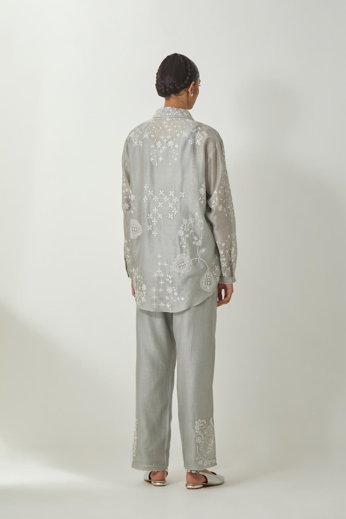 Bluish Grey silk Chanderi shirt with all-over off white silk thread embroidery, highlighted with sequins and beads work, paired with Bluish Grey silk Chanderi straight pants with embroidered boota at sides, highlighted with sequins and beads.