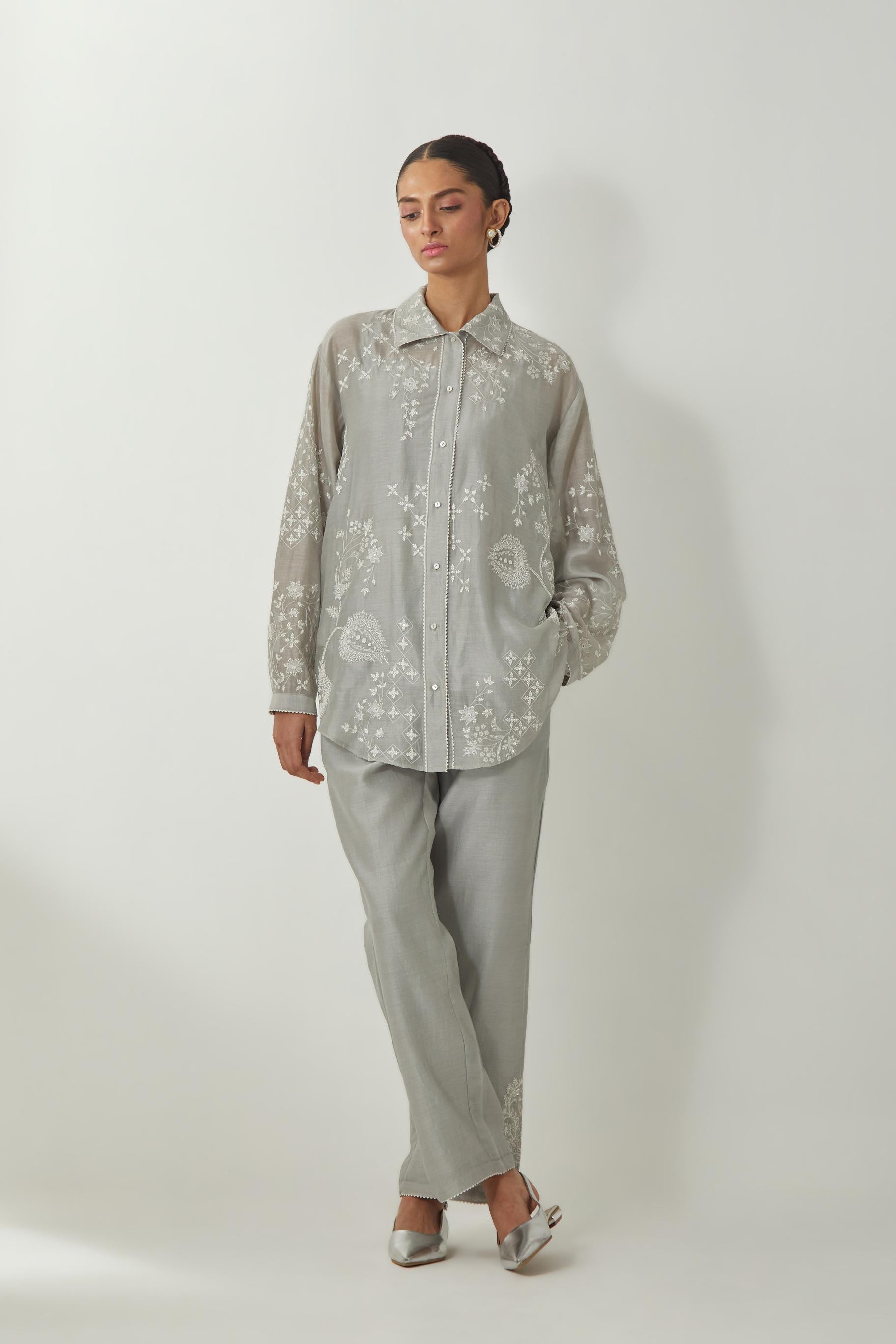 Bluish Grey silk Chanderi shirt with all-over off white silk thread embroidery, highlighted with sequins and beads work, paired with Bluish Grey silk Chanderi straight pants with embroidered boota at sides, highlighted with sequins and beads.