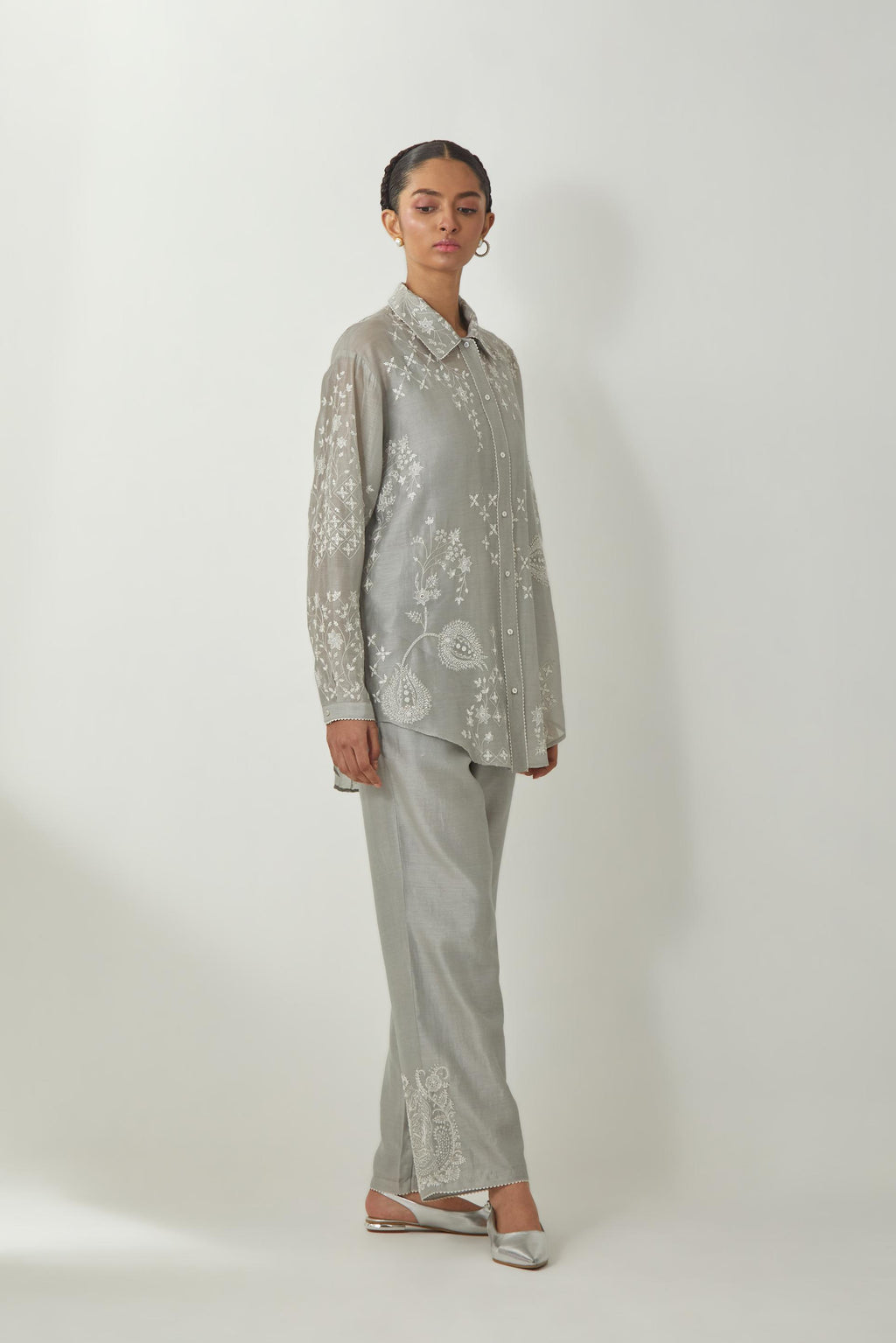 Bluish Grey silk Chanderi shirt with all-over off white silk thread embroidery, highlighted with sequins and beads work, paired with Bluish Grey silk Chanderi straight pants with embroidered boota at sides, highlighted with sequins and beads.