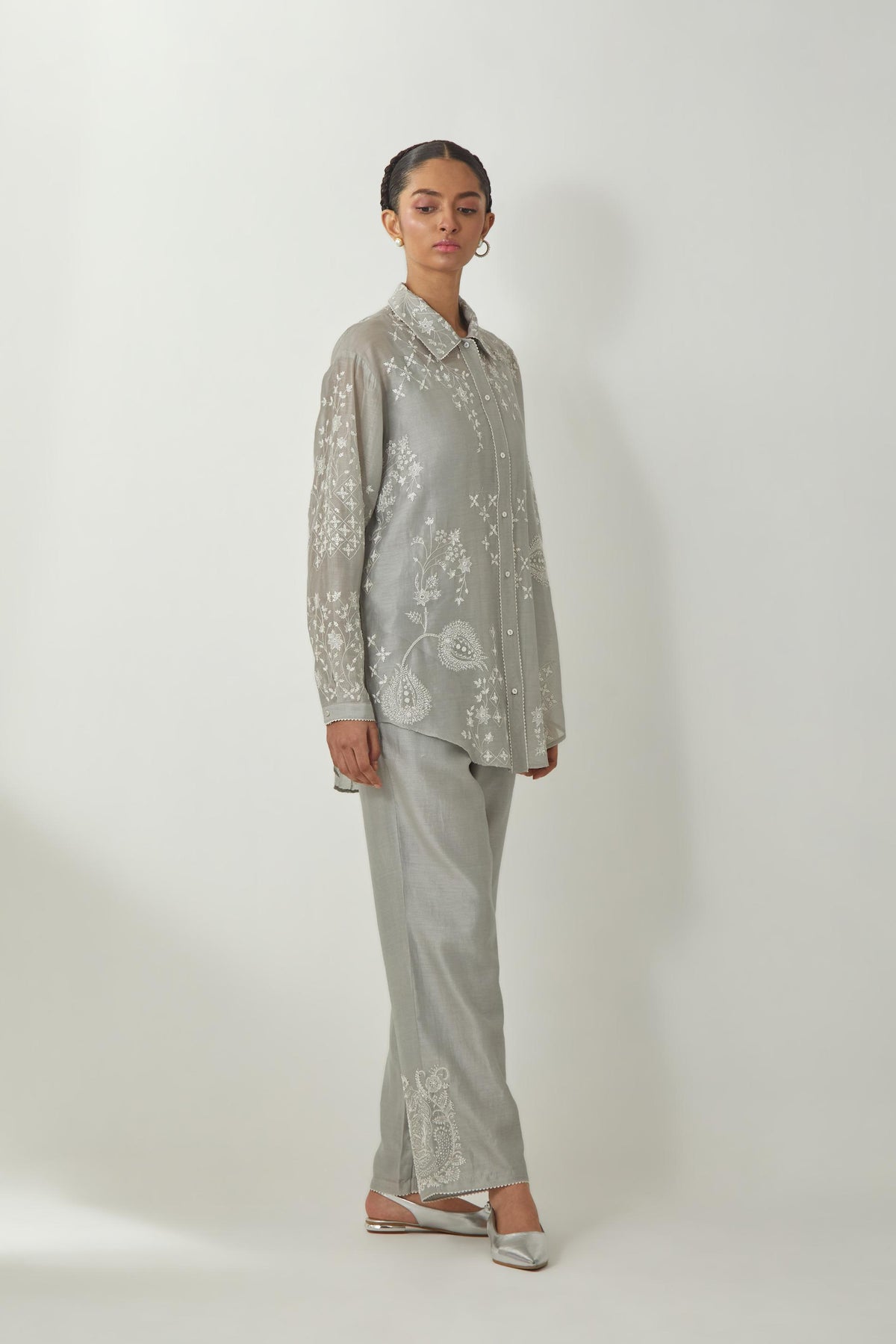 Bluish Grey silk Chanderi shirt with all-over off white silk thread embroidery, highlighted with sequins and beads work, paired with Bluish Grey silk Chanderi straight pants with embroidered boota at sides, highlighted with sequins and beads.