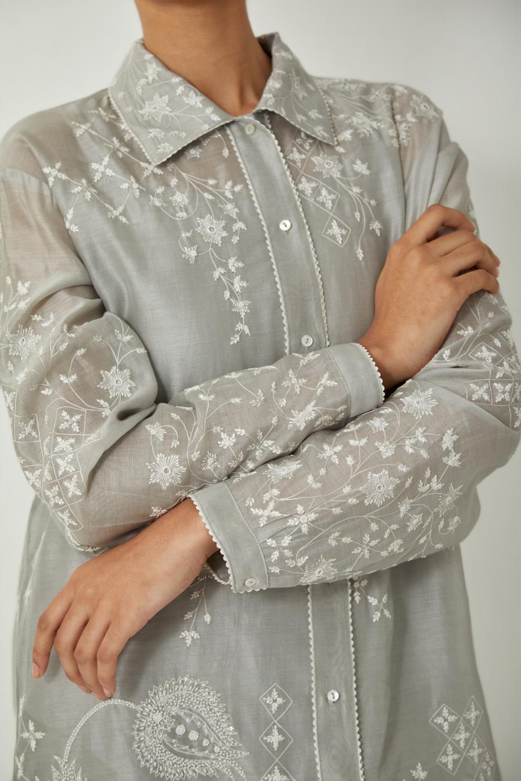 Bluish Grey silk Chanderi shirt with all-over off white silk thread embroidery, highlighted with sequins and beads work, paired with Bluish Grey silk Chanderi straight pants with embroidered boota at sides, highlighted with sequins and beads.