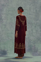 Deep maroon straight long kurta set in Silk Velvet with hand-embroidered bead, sequins and zari detailing on neck, sleeves and hem.