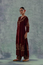 Deep maroon straight long kurta set in Silk Velvet with hand-embroidered bead, sequins and zari detailing on neck, sleeves and hem.