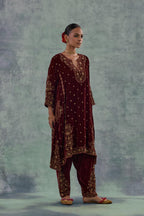 Deep maroon easy fit A-line, panelled, short kurta set in silk velvet with all-over hand embroidery at the neck, sleeves and hem.