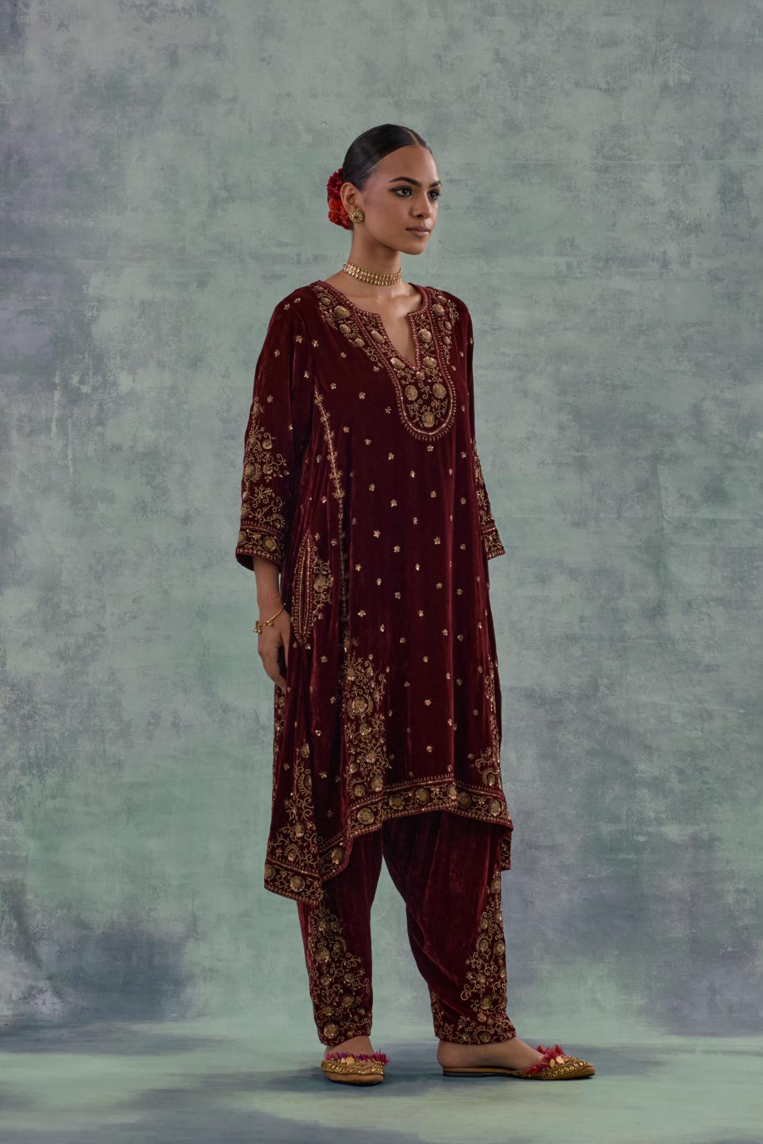 Deep maroon easy fit A-line, panelled, short kurta set in silk velvet with all-over hand embroidery at the neck, sleeves and hem.