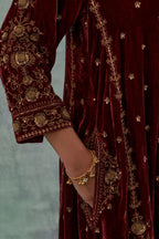 Deep maroon easy fit A-line, panelled, short kurta set in silk velvet with all-over hand embroidery at the neck, sleeves and hem.