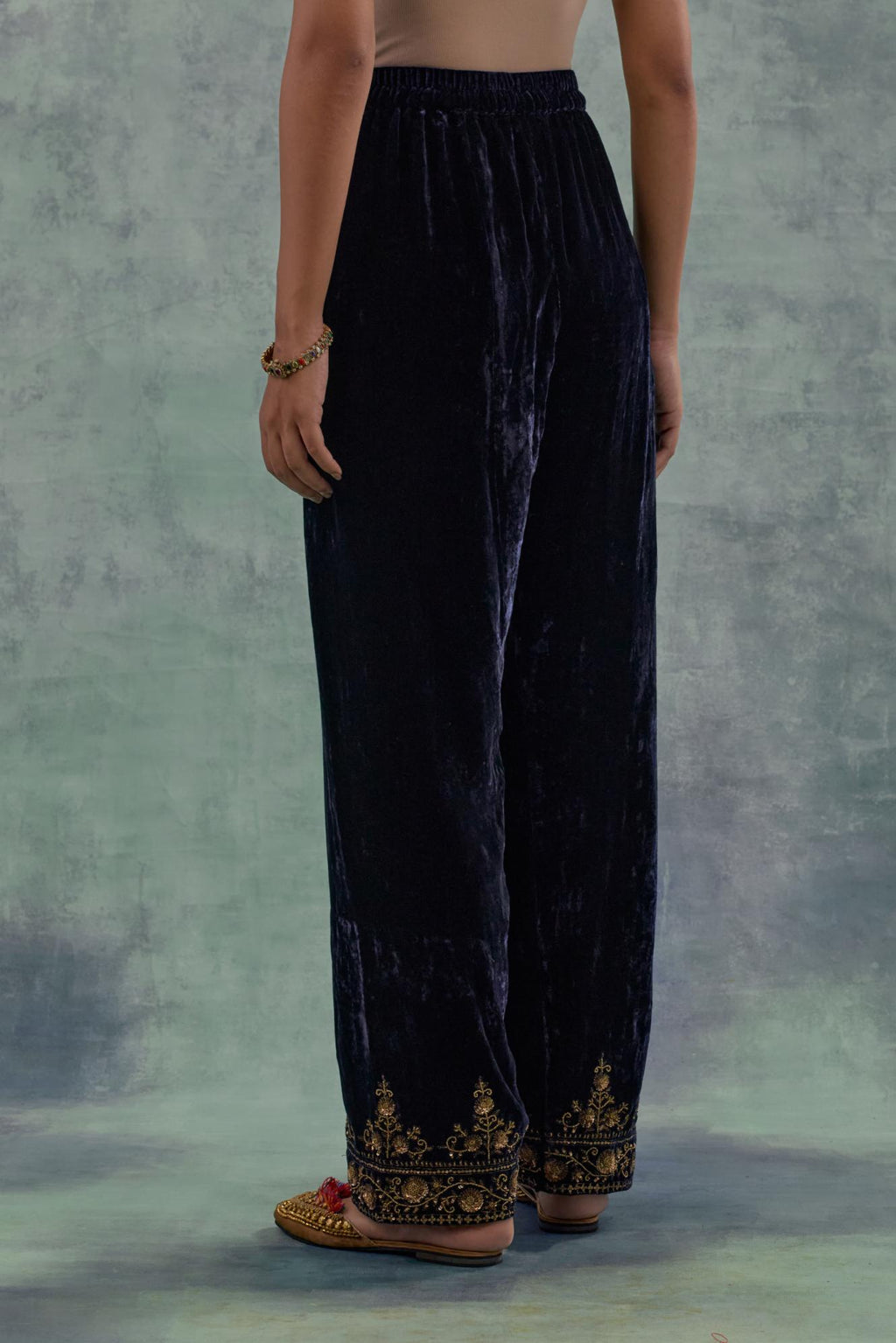 Navy Silk velvet straight pants. The hem is highlighted with hand-embroidered bead, sequins and zari motifs.