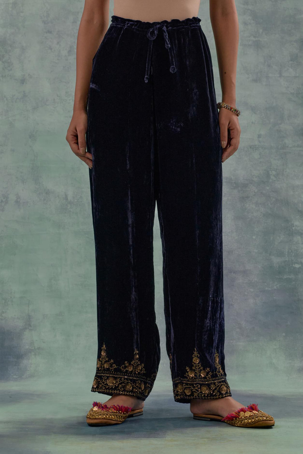 Navy Silk velvet straight pants. The hem is highlighted with hand-embroidered bead, sequins and zari motifs.