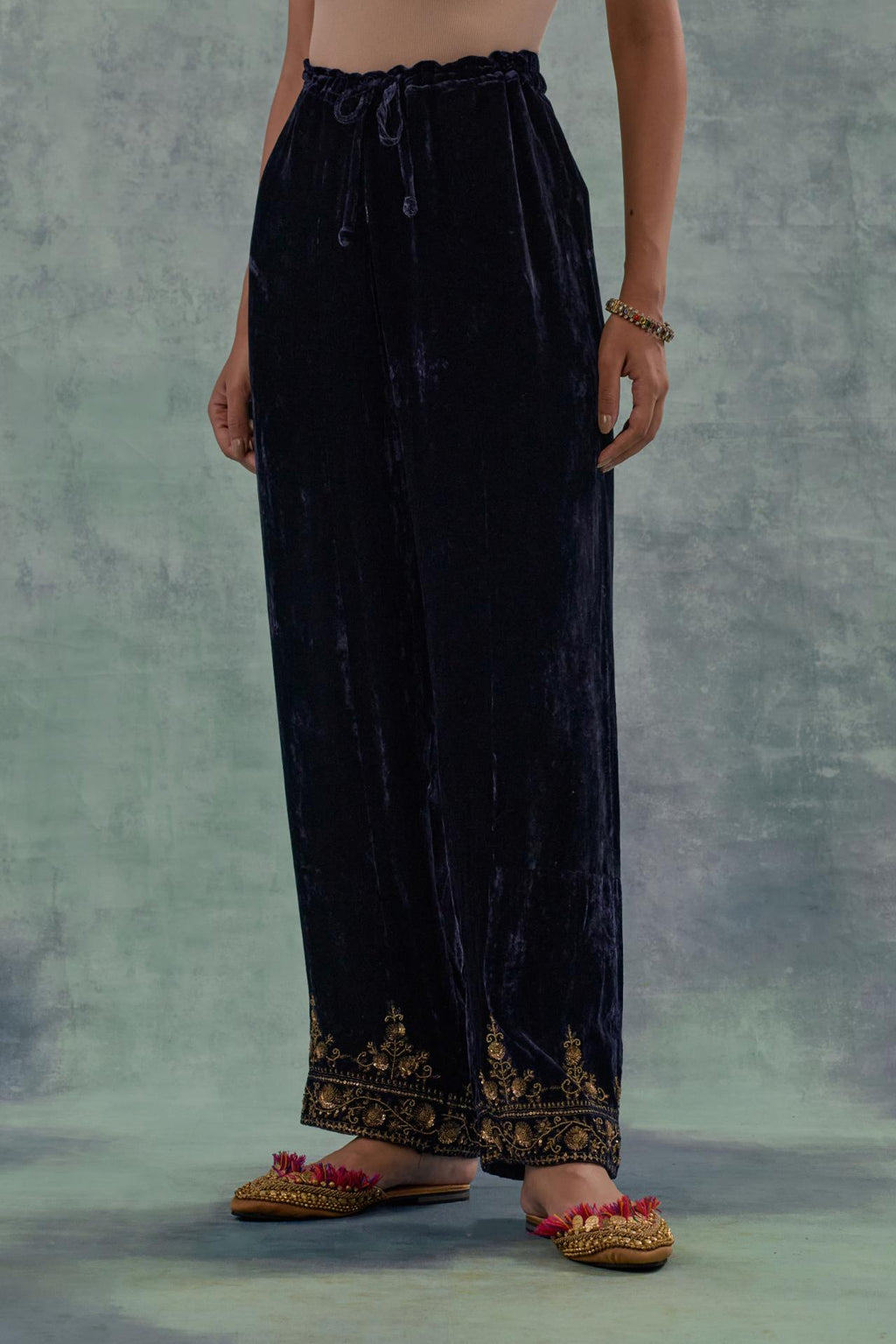 Navy Silk velvet straight pants. The hem is highlighted with hand-embroidered bead, sequins and zari motifs.