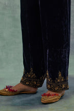 Navy Silk velvet straight pants. The hem is highlighted with hand-embroidered bead, sequins and zari motifs.