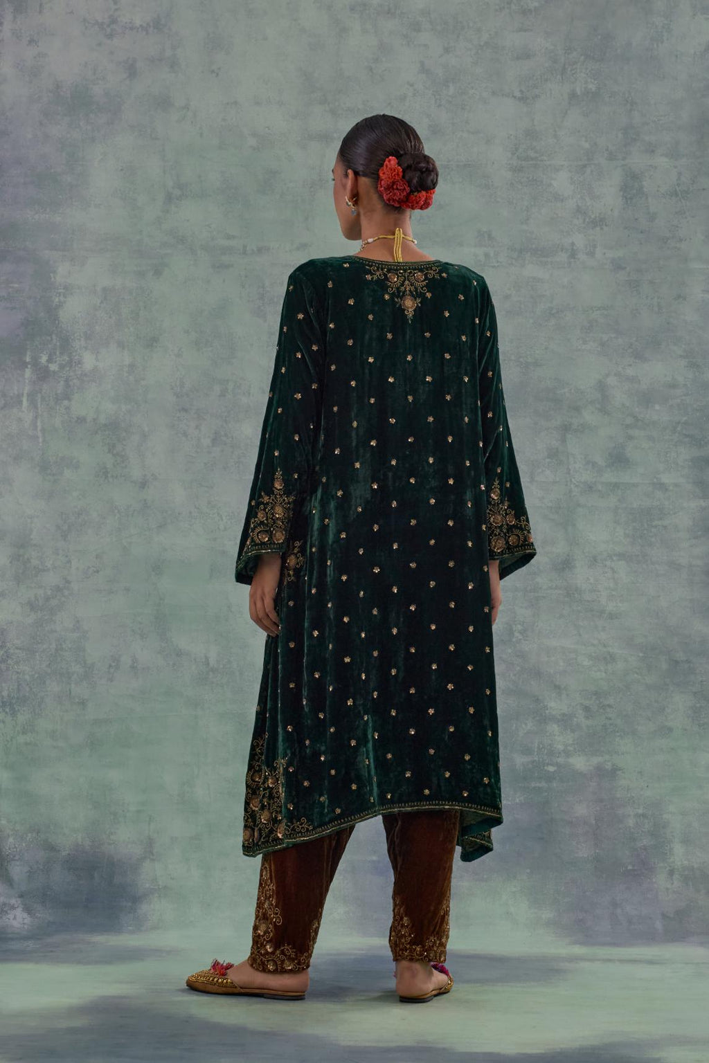 Emerald green easy fit A-line short kurta set in silk velvet with all-over bead, sequins and zari hand embroidery.