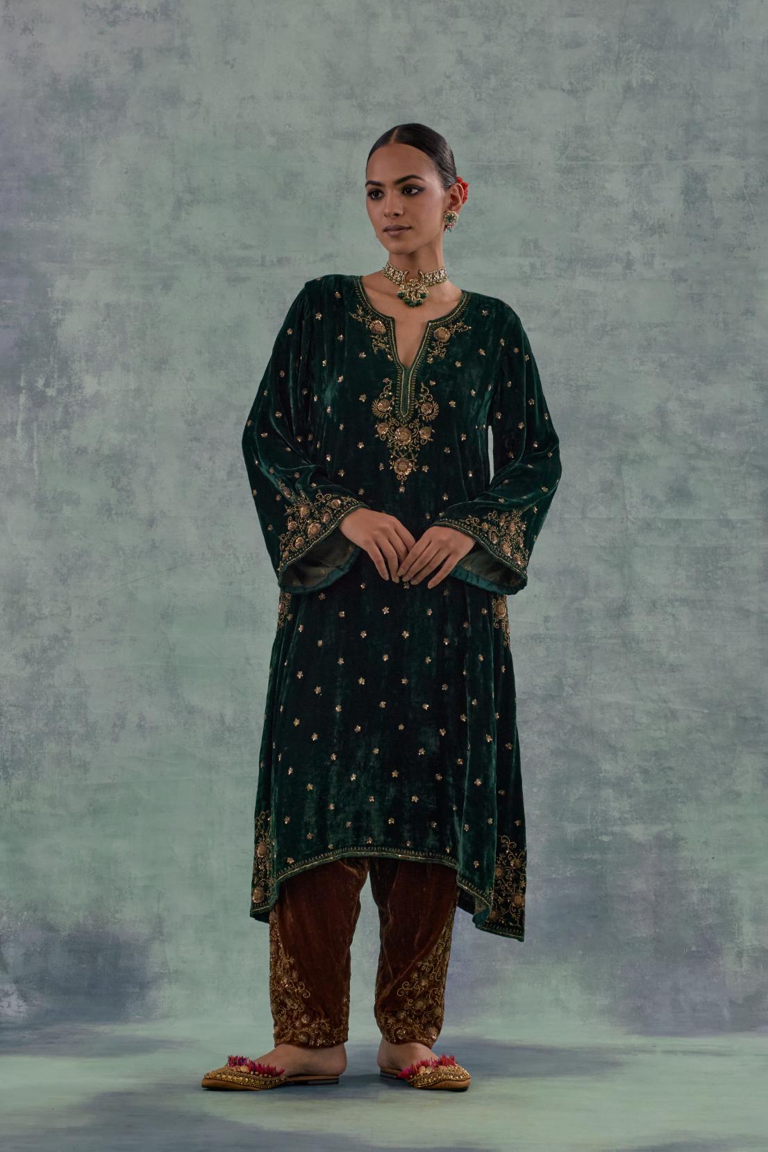 Emerald green easy fit A-line short kurta set in silk velvet with all-over bead, sequins and zari hand embroidery.