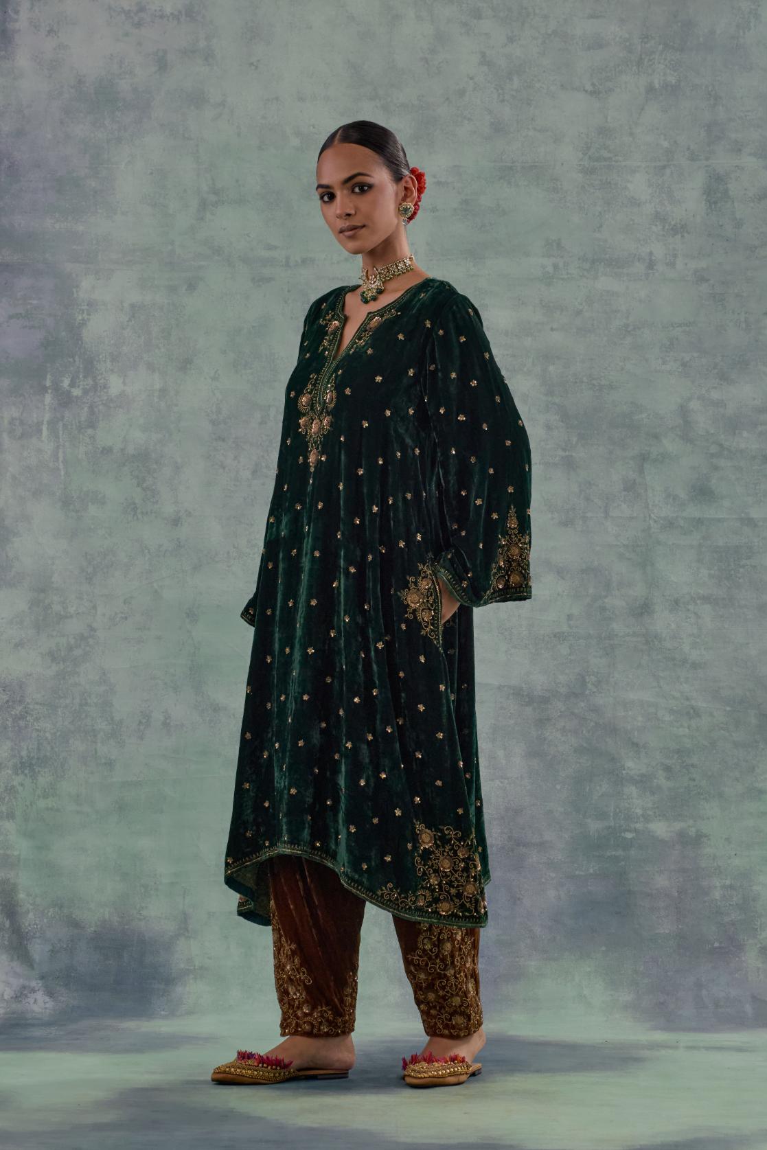 Emerald green easy fit A-line short kurta set in silk velvet with all-over bead, sequins and zari hand embroidery.