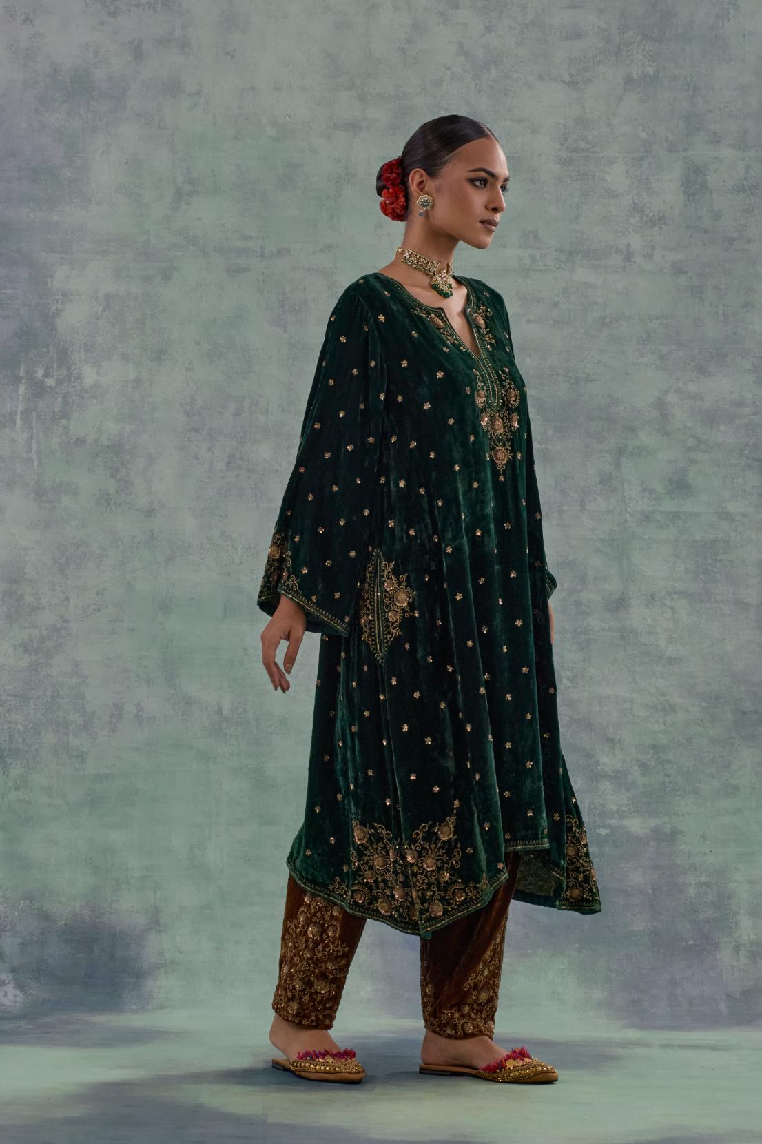 Emerald green easy fit A-line short kurta set in silk velvet with all-over bead, sequins and zari hand embroidery.