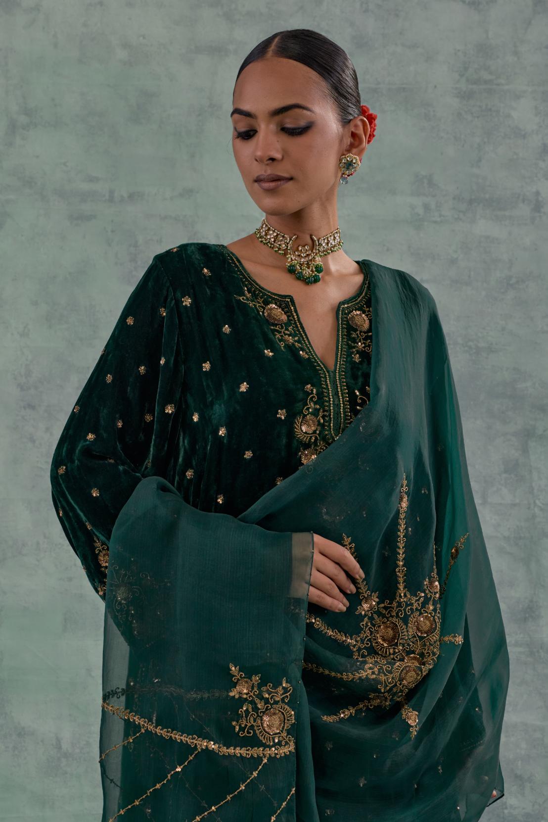 Emerald green easy fit A-line short kurta set in silk velvet with all-over bead, sequins and zari hand embroidery.