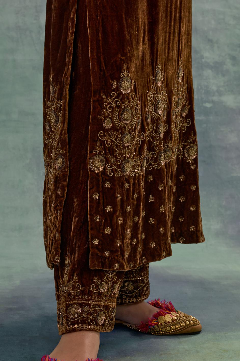 Deep maroon straight long kurta set in Silk Velvet with hand-embroidered bead, sequins and zari detailing on neck, sleeves and hem.