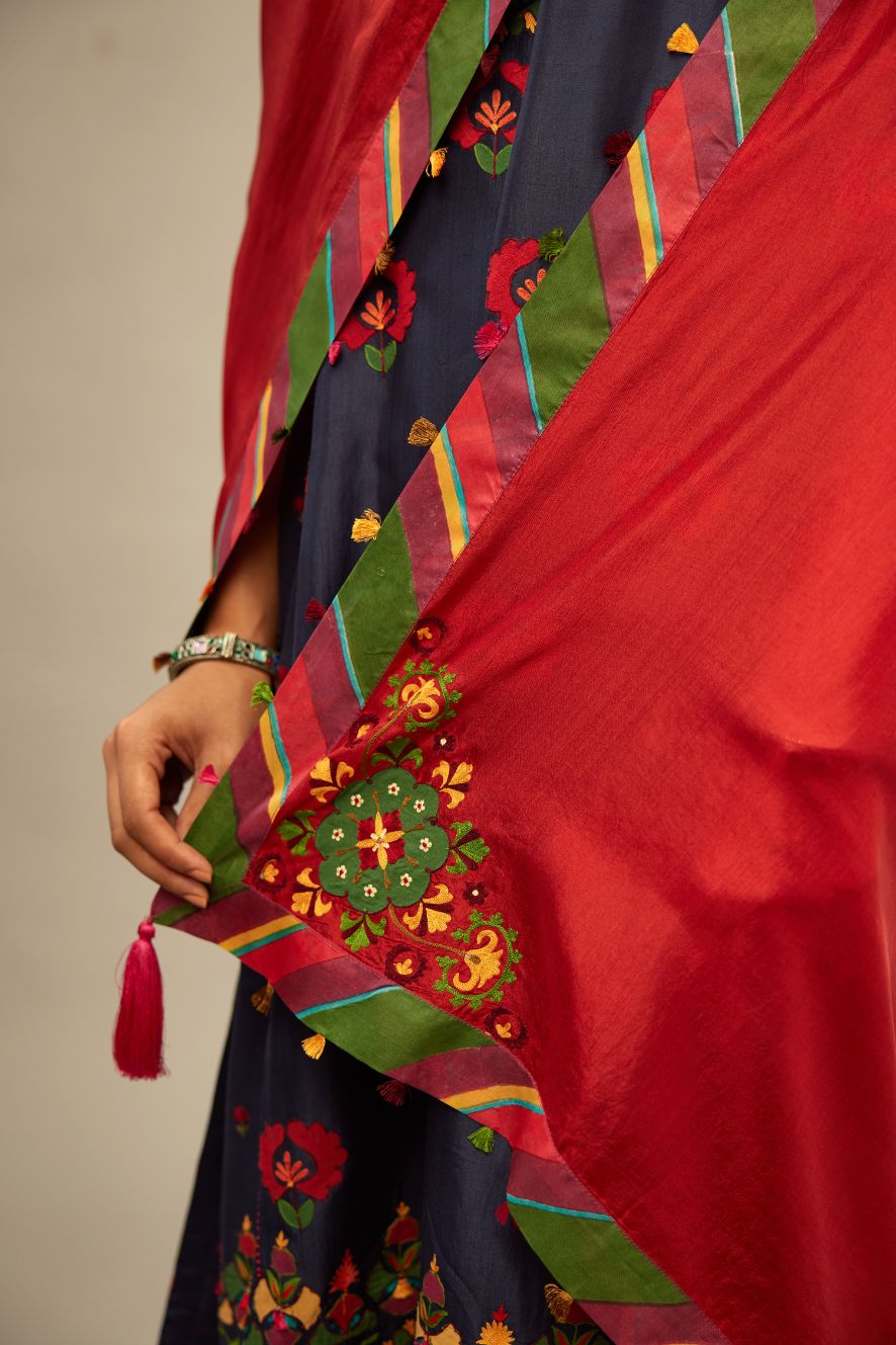 Light silk red stole with a bold striped silk border edged with multi-colored silk tassels on all four sides.