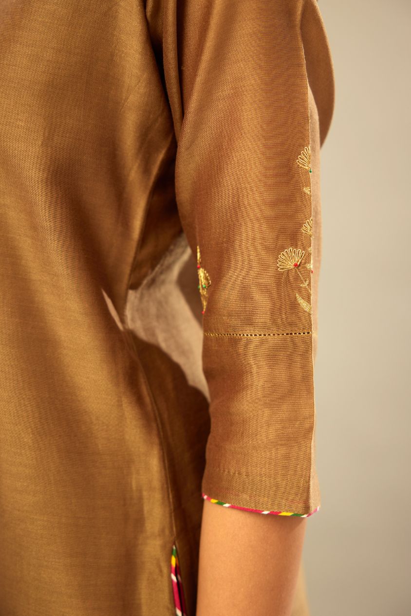 Olive straight kurta set with silver zari and contrasting thread embroidery, hem and sleeves highlighted with zari faggoting.