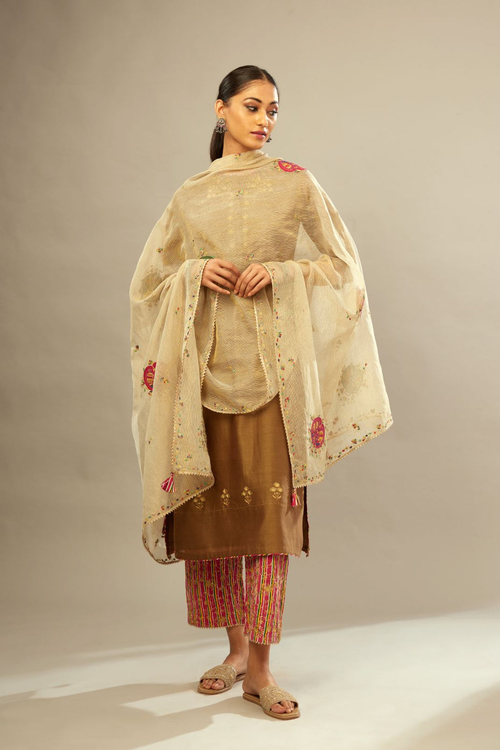 Olive straight kurta set with silver zari and contrasting thread embroidery, hem and sleeves highlighted with zari faggoting.