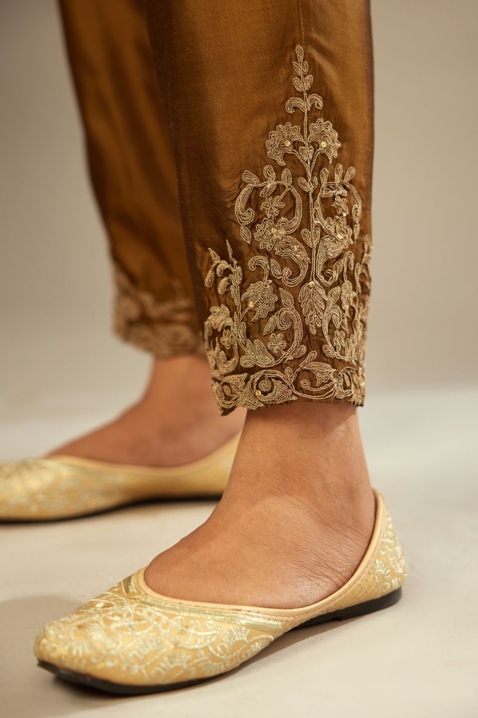 Golden olive silk pants with dori embroidered bootas at hem.