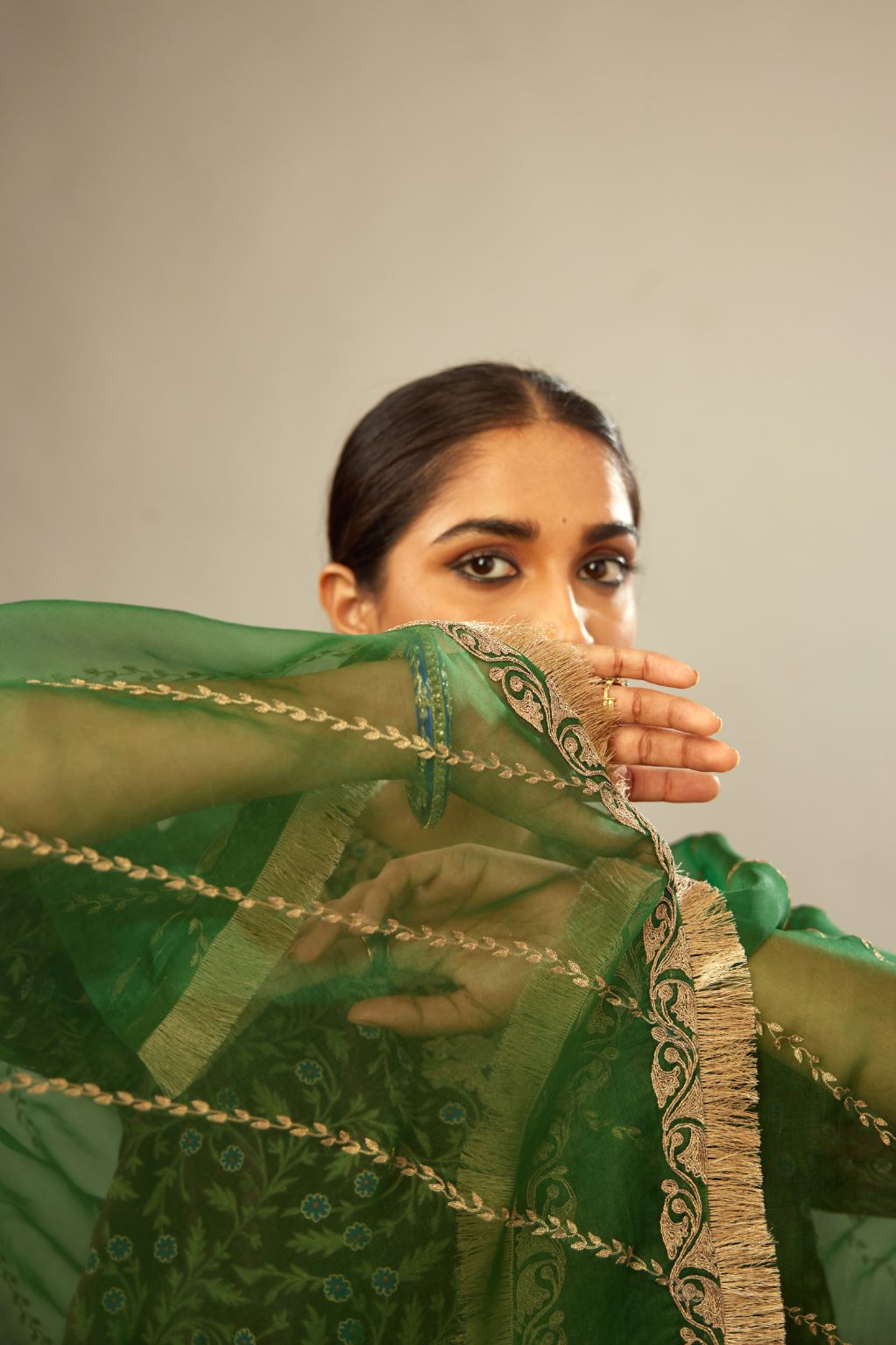 Dark green silk organza dupatta with dori embroidery border at the edges and diagonal zari embroidered lines all-over the dupatta.