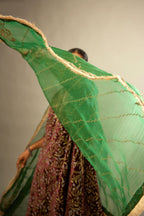 Dark green silk organza dupatta with dori embroidery border at the edges and diagonal zari embroidered lines all-over the dupatta.