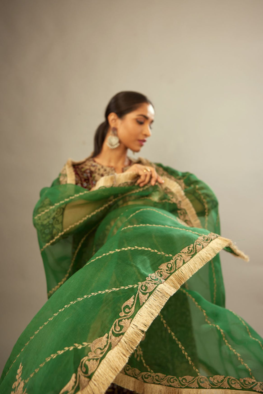 Dark green silk organza dupatta with dori embroidery border at the edges and diagonal zari embroidered lines all-over the dupatta.