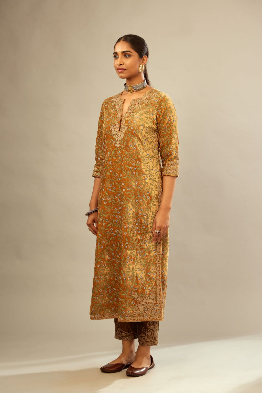 Mustard yellow silk velvet straight kurta set with delicate thread embroidery jaal all-over offset with bold gold dori embroidery at neck, sleeves and hem.